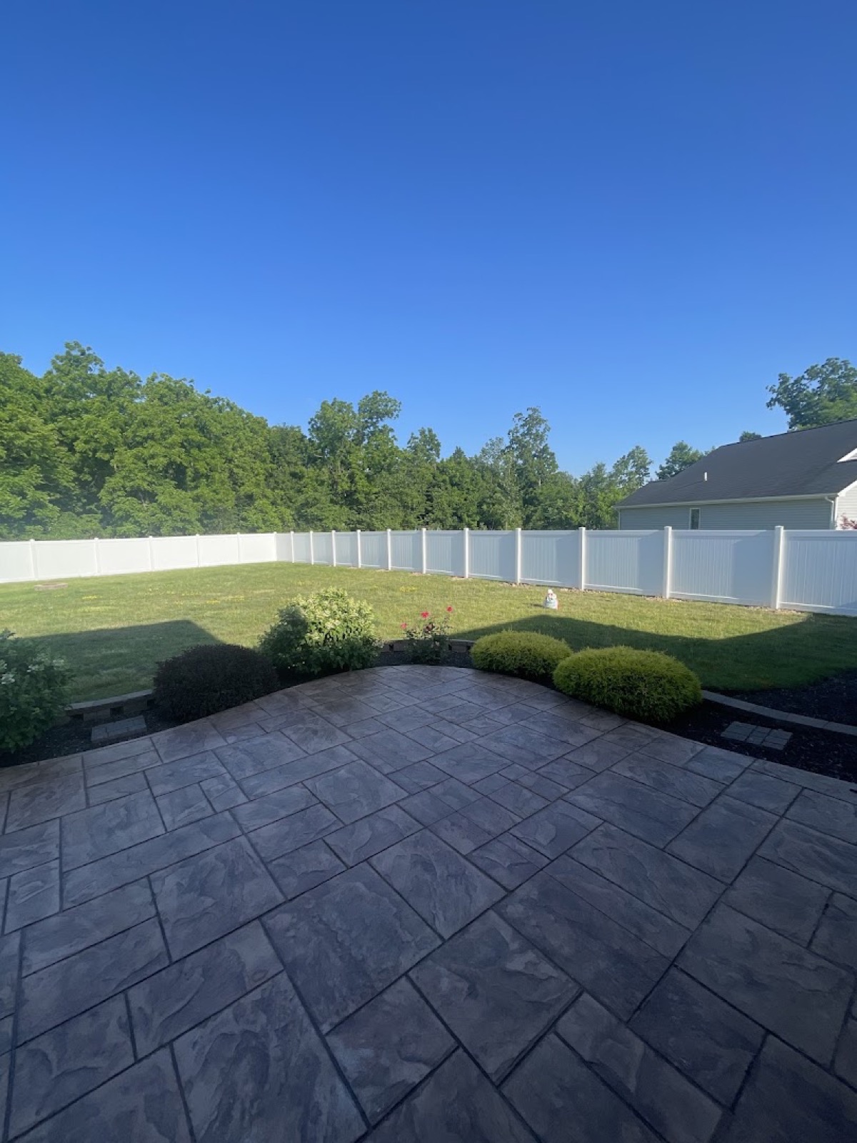 A finished cedar privacy fence with clean posts and fresh landscaping by Fort Wayne Fence