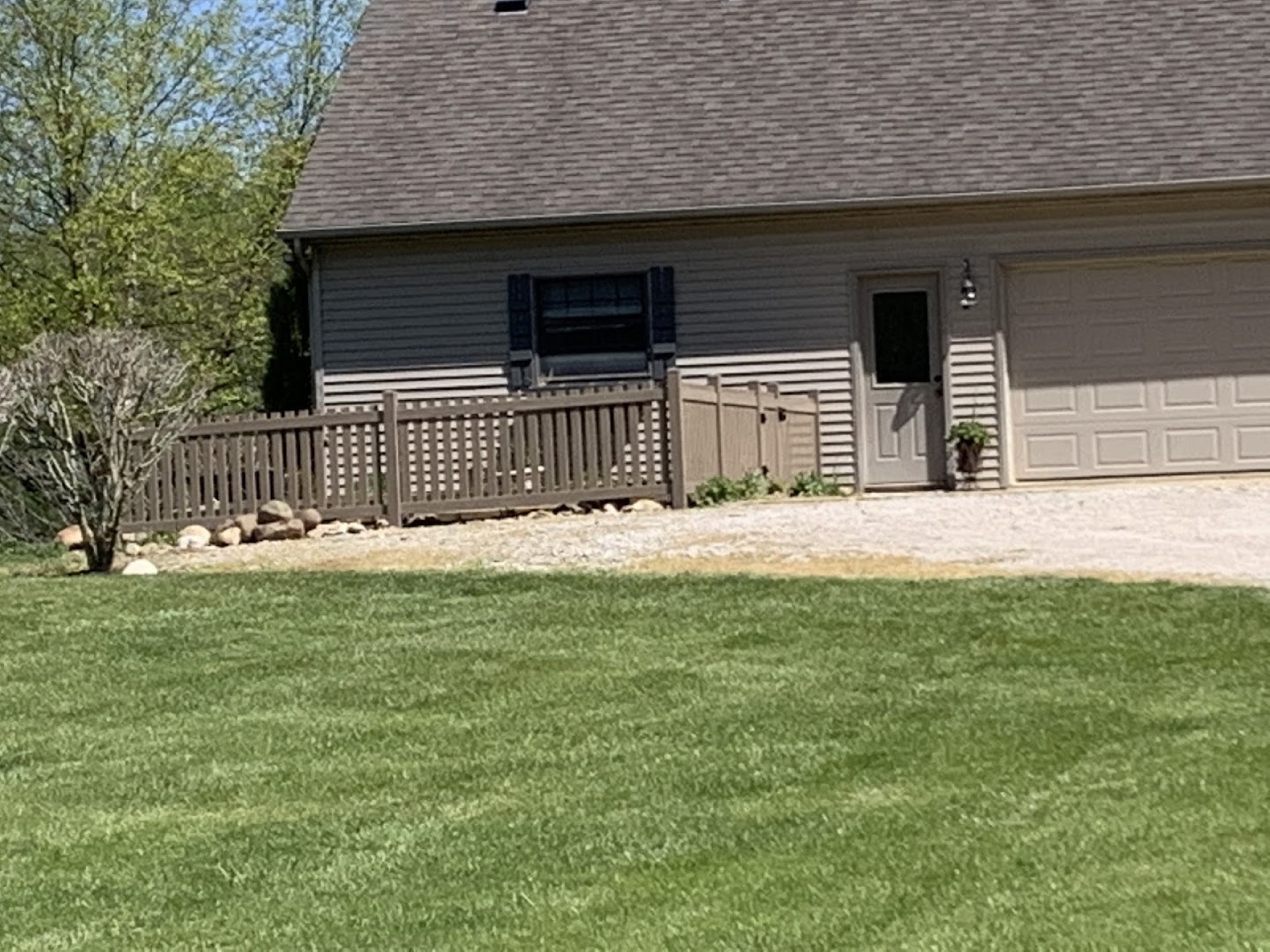 A black fence line beside a Fort Wayne home