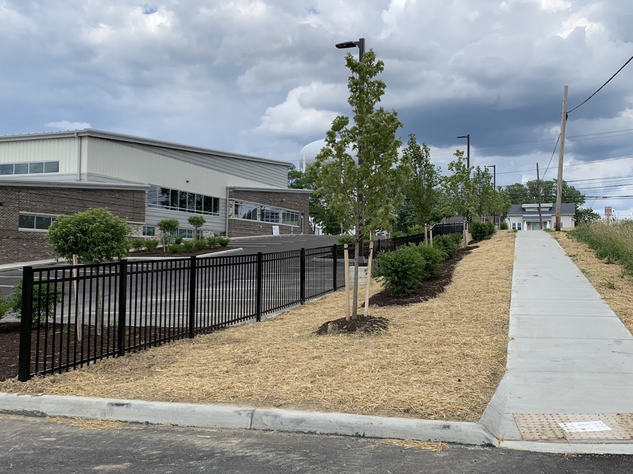 A long run of black steel fencing installed by Fort Wayne Fence