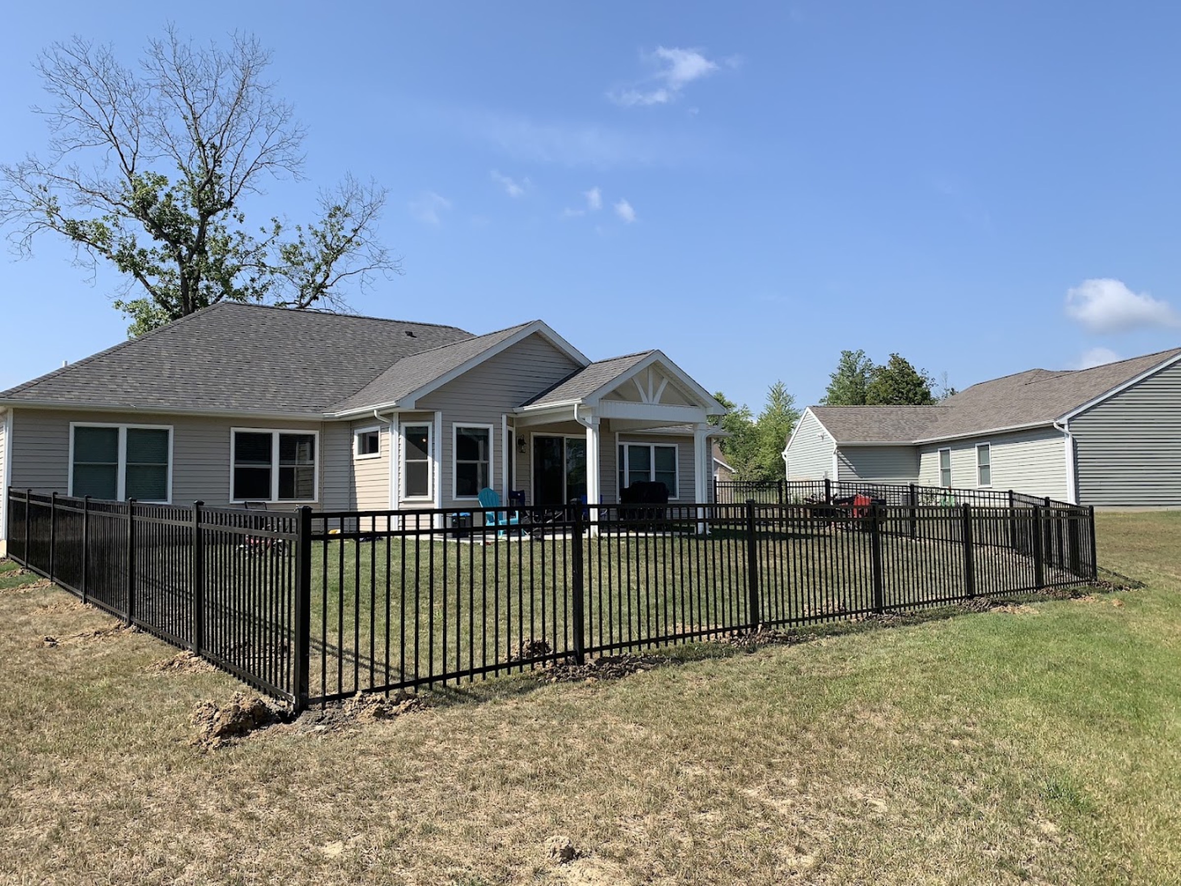 A tall wood privacy fence built by Fort Wayne Fence running the length of a back yard