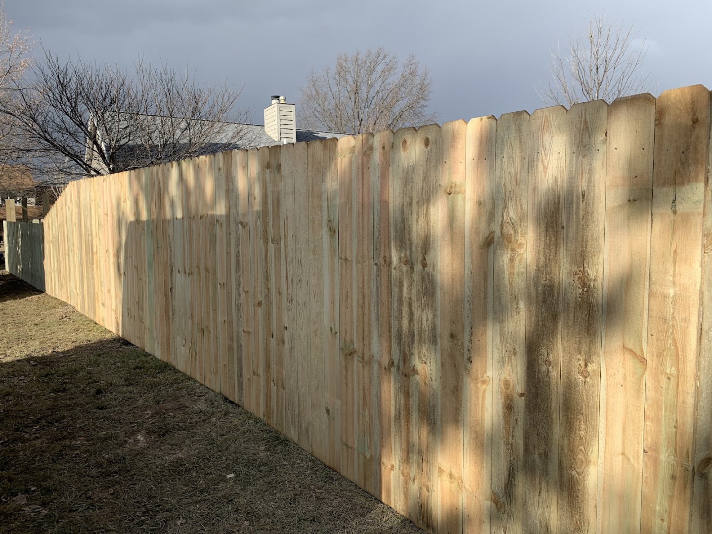 A tall wood privacy fence installed by Fort Wayne Fence