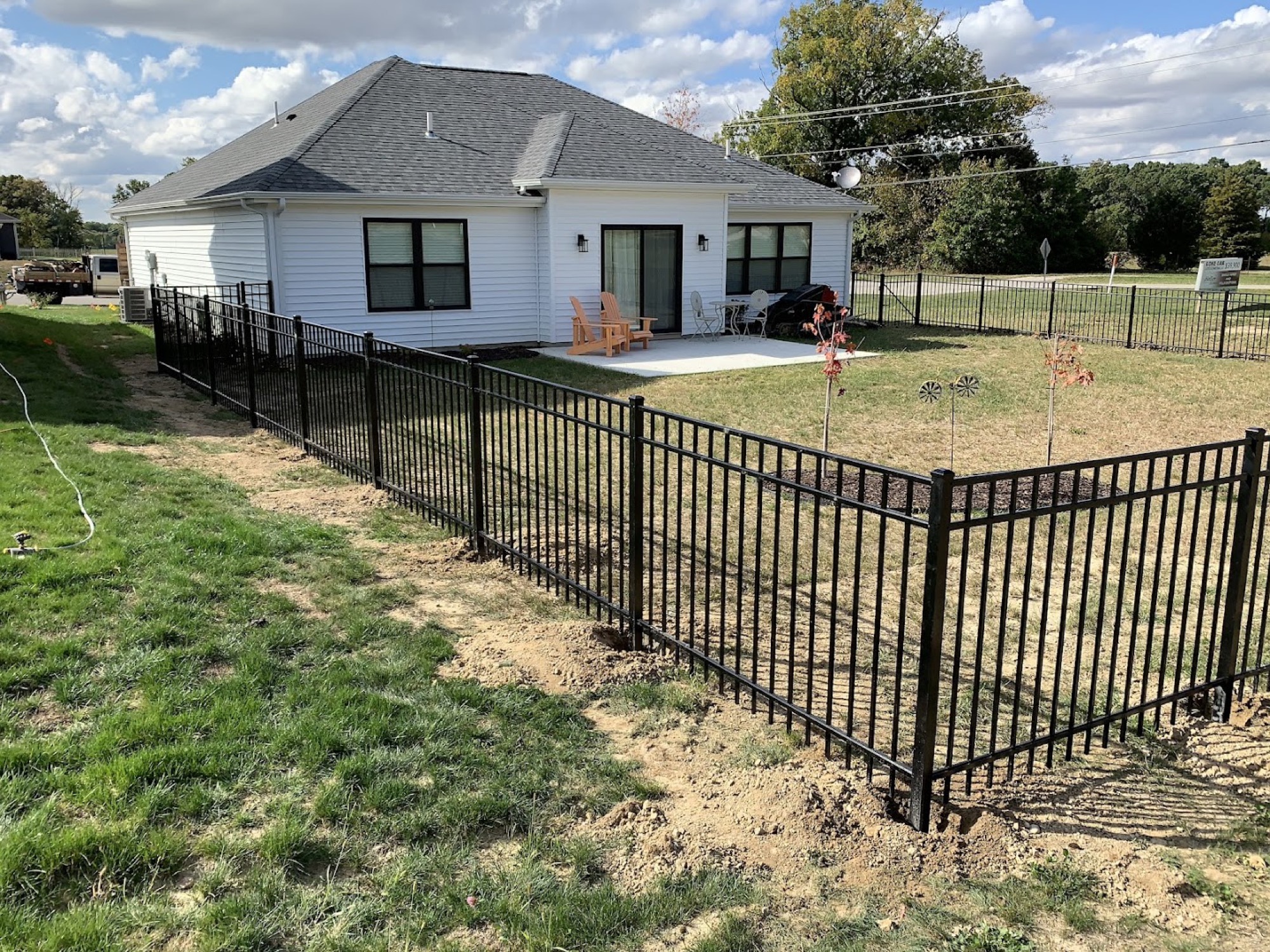 A black ornamental fence around a Fort Wayne back yard
