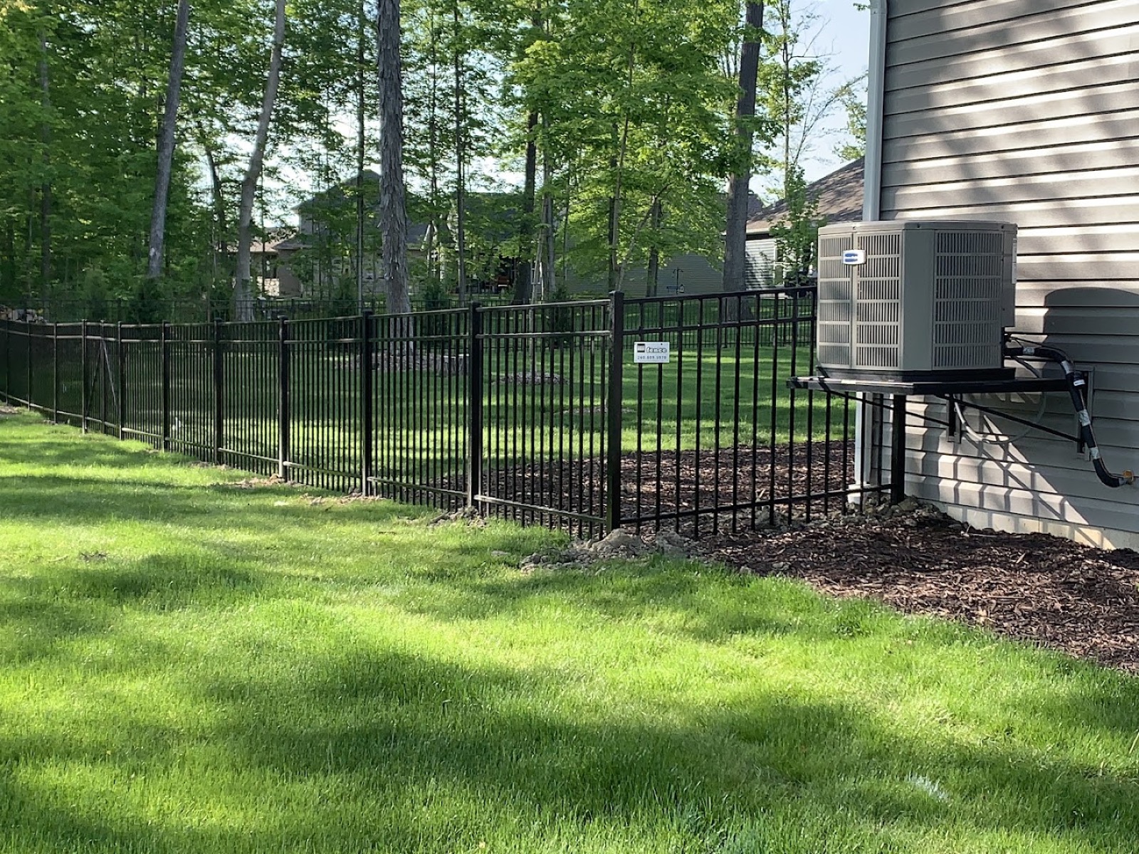 A wood fence section being repaired in Fort Wayne