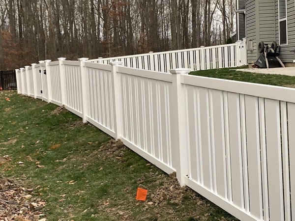 A long white vinyl privacy fence in a Fort Wayne back yard