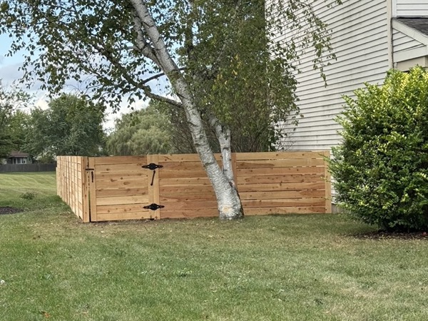 A newly built wood fence in a back yard