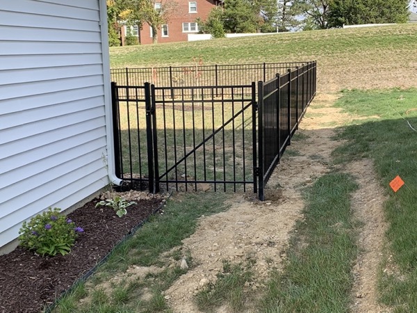 A black ornamental gate and fence on a Fort Wayne property