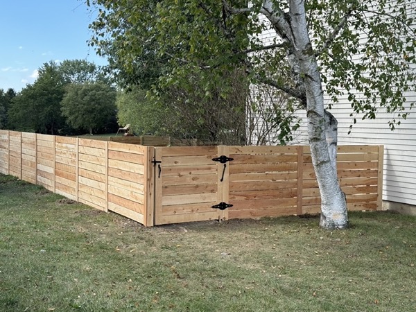 A wood fence built along a property line