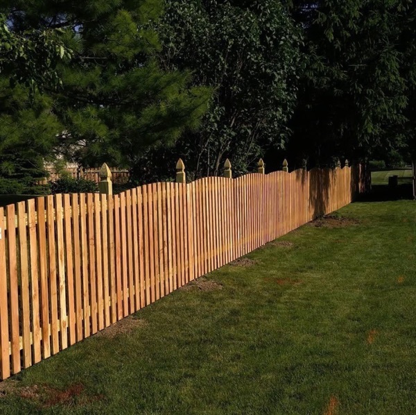 A cedar picket fence running along a Fort Wayne back yard